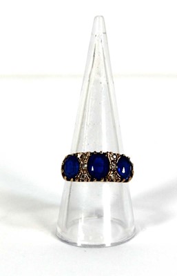 Lot 777 - A 9ct yellow gold dress ring set three oval...