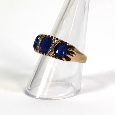 Lot 777 - A 9ct yellow gold dress ring set three oval...