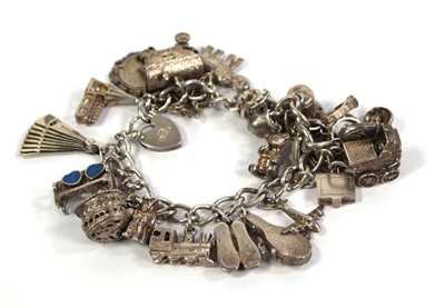 Lot 782 - A silver curblink bracelet with heart shaped...