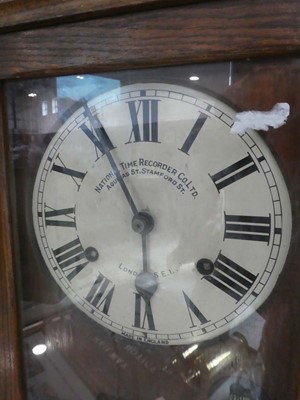 Lot Dark oak cased clocking in machine by National...