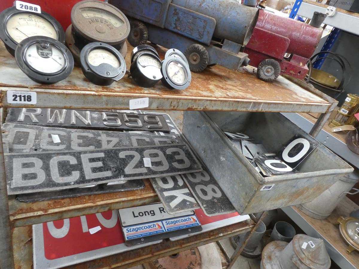 Lot Shelf containing vintage number plates with...