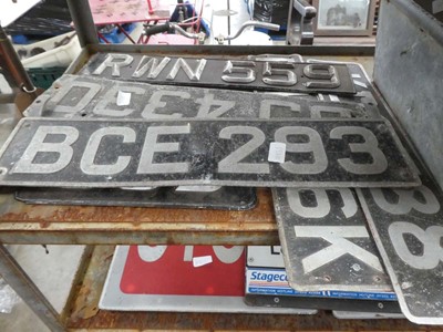 Lot Shelf containing vintage number plates with...