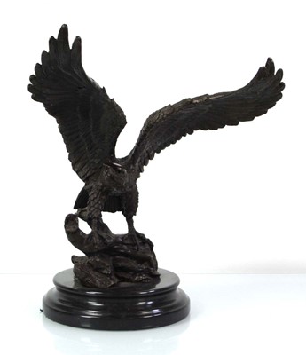 Lot 56 - A bronze sculpture modelled as an eagle with...