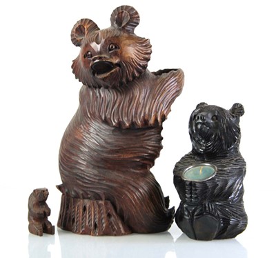 Lot 69 - A Black Forest style carved wooden bottle...