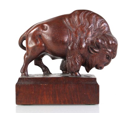Lot 73 - A carved oak sculpture modelled as a bison,...