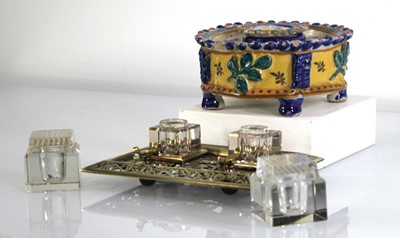Lot 93 - A brass desk tidy with two glass inkwells and...