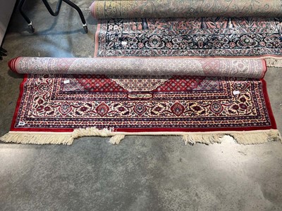 Lot 1650 - Tasseled woolen figured and bordered rug on...