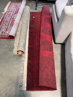 Lot 1652 - Tasseled red and navy patterned rug