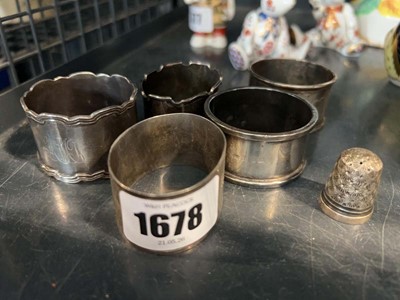 Lot 1678 - 5 hallmarked silver napkin rings and 1 thimble
