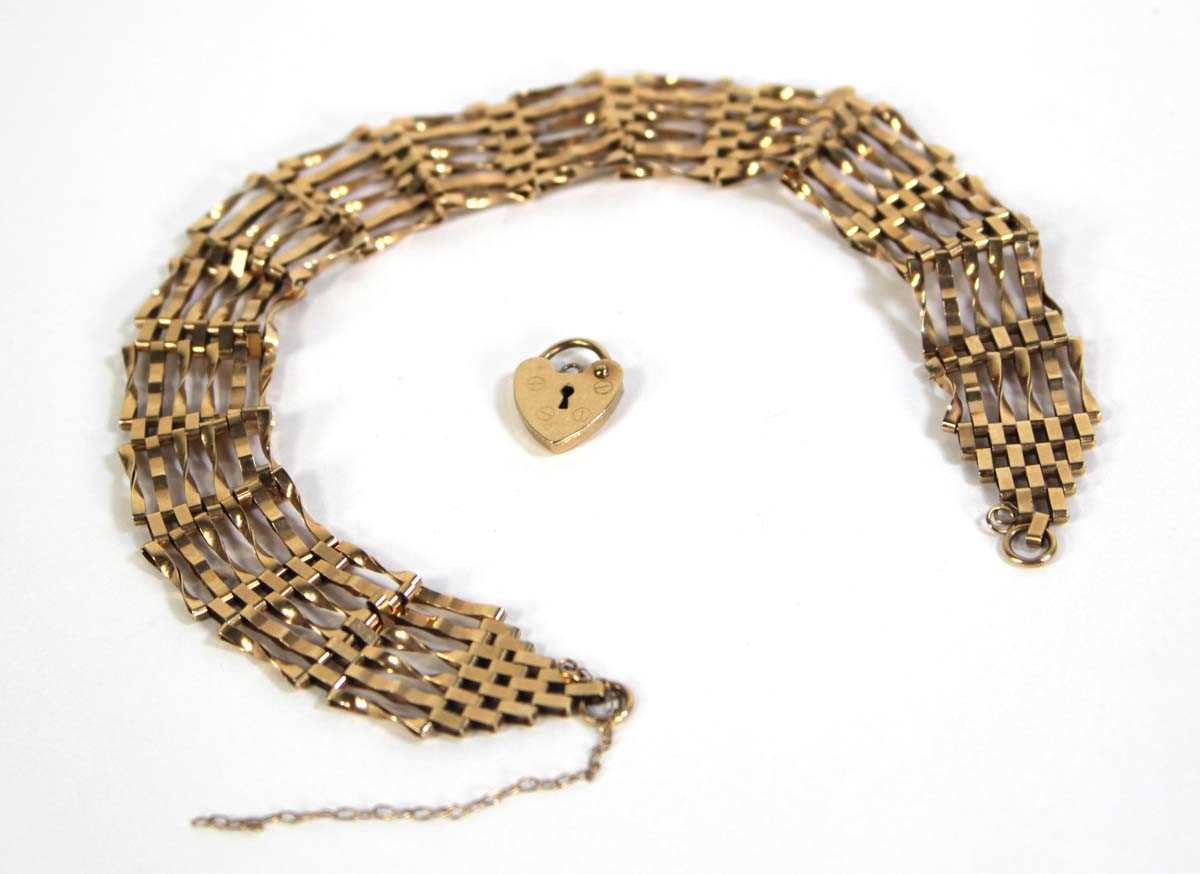 Lot 795 - A 9ct yellow gold six bar gatelink bracelet...