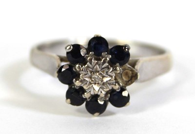 Lot 803 - A 9ct white gold cluster ring set diamond and...