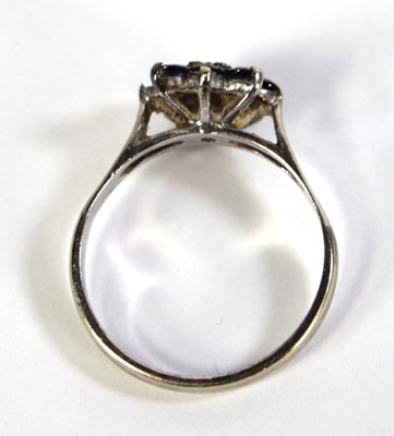 Lot 803 - A 9ct white gold cluster ring set diamond and...