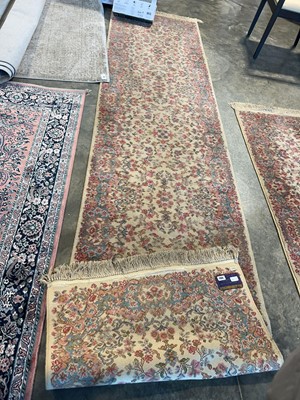 Lot 1186 - Pink and cream decorative patterned rug by...