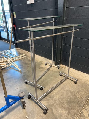 Lot 1236 - 2 clothes hanging rails with glass tops