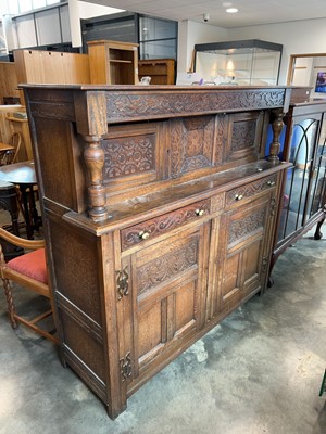 Lot 1305 - Dark oak heavily carved sideboard