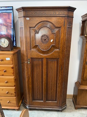 Lot 1313 - Dark oak heavily carved single door wardrobe